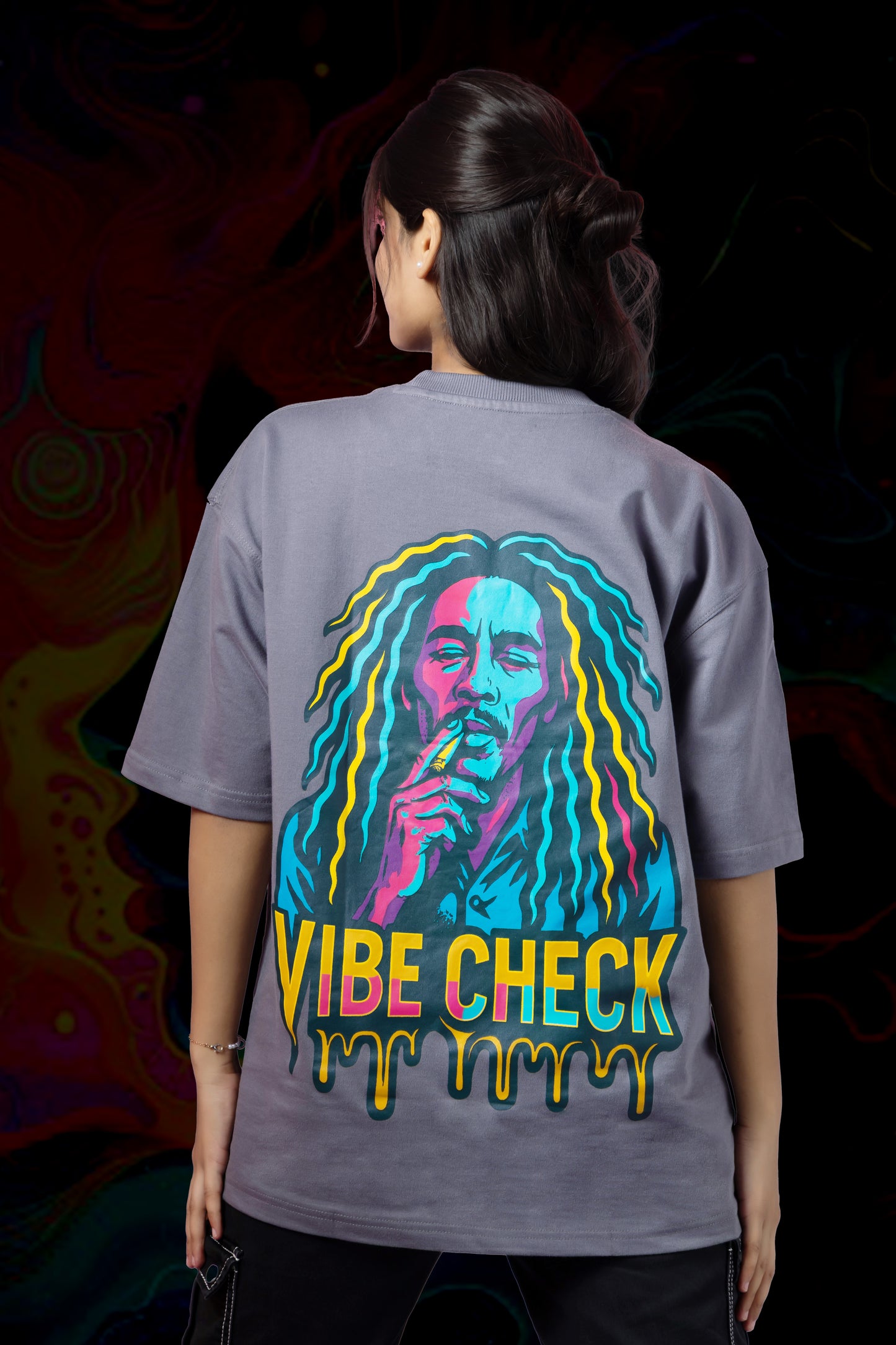 Person wearing a gray t-shirt with a colorful graphic and 'Vibe Check' text on the back.